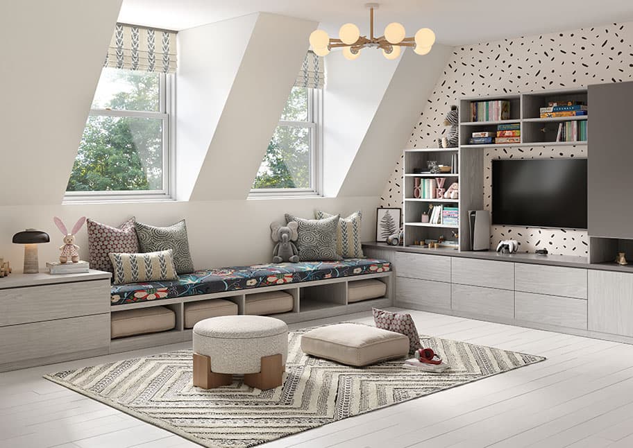 Sala de juegos personalizada transformada a partir de un espacio de ático sin uso con un centro multimedia para guardar juguetes, cubículos y estantes de biblioteca para niños creados por California Closets
