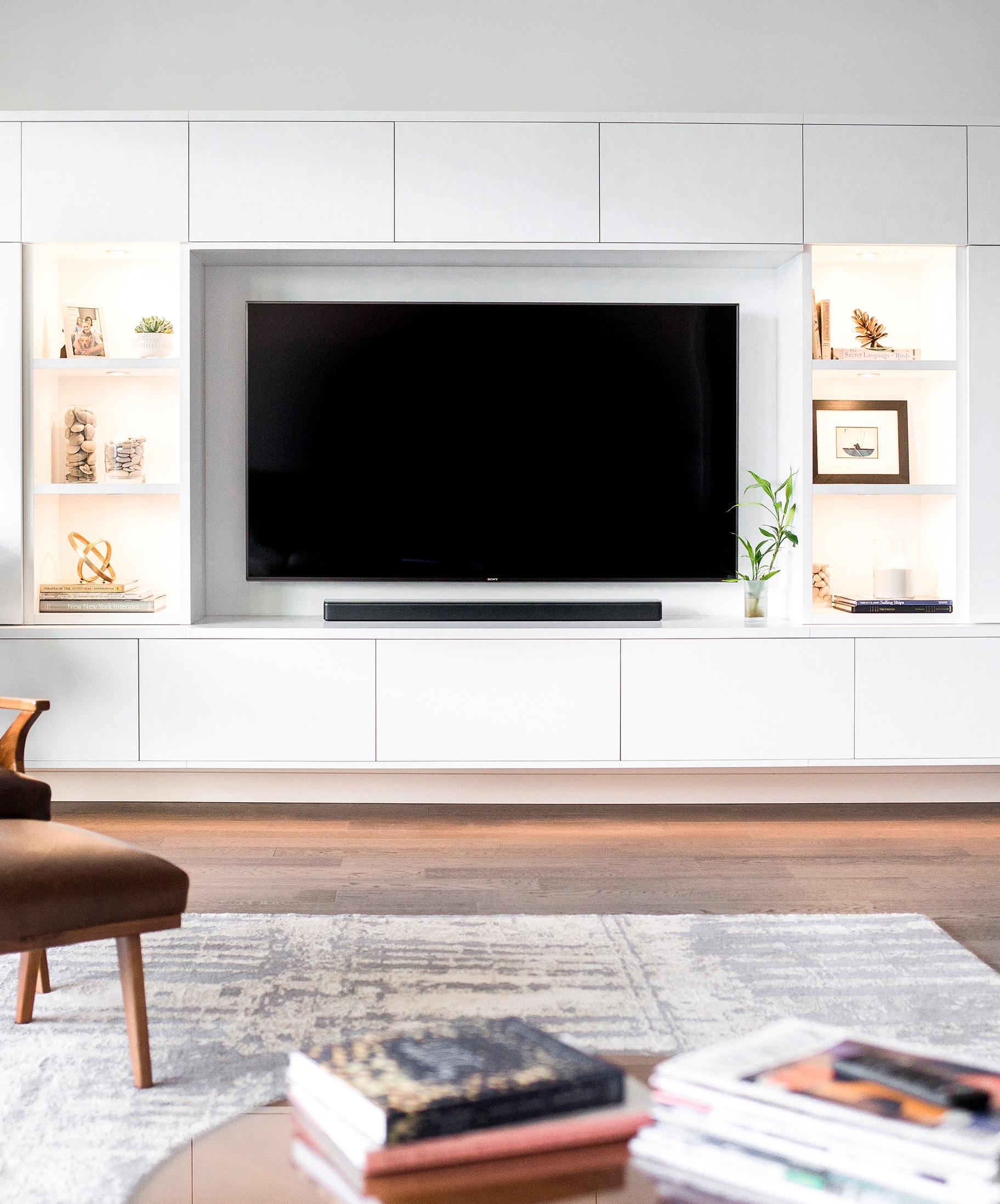 Media center custom cabinets in a dove finish for storage by California Closets