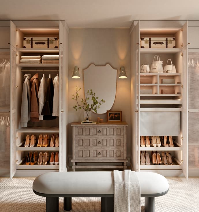 Walk in closet designed with custom cabinets, shoe storage, specialty lighting in light wood grain finish by California Closets