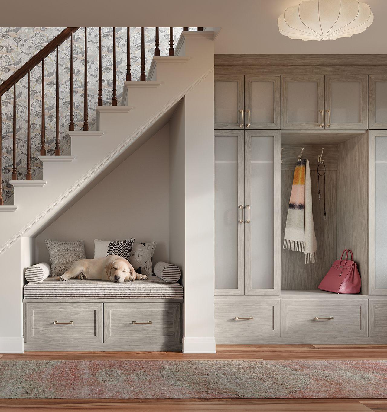 Mudroom storage bench with custom cabinets and drawers in a light grain finish by California Closets
