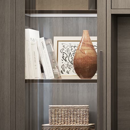 Custom shelving design with glass and led lighting for storage by California Closets