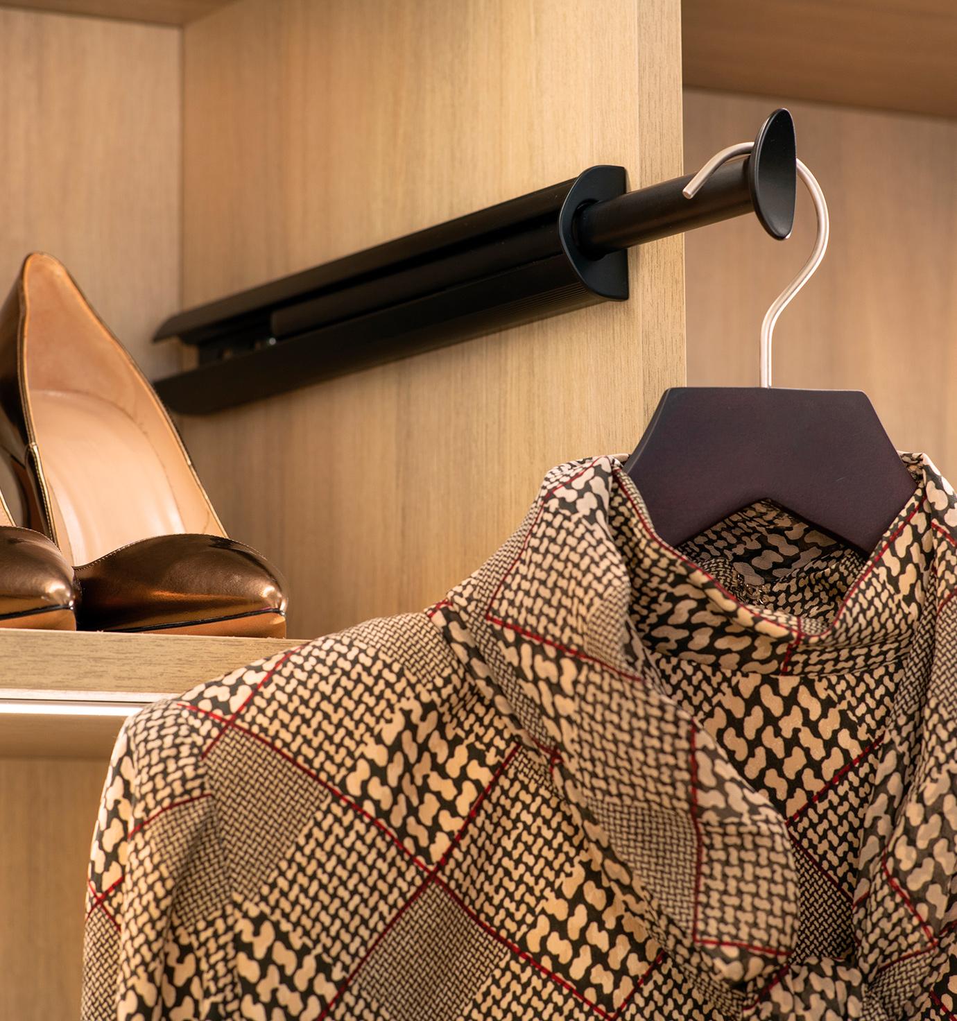 Closet accessories valet rod inside closet with custom shelf by California Closets
